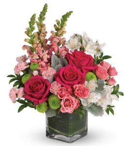Hot pink Stunning roses, delicate alstroemeria and dramatic snapdragons are hand-delivered in a classic cube vase lined with a green leaf