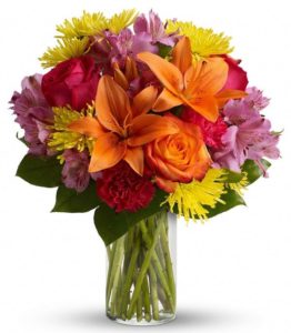 Express yourself colorfully with a brilliant array of roses, lilies and other favorites beautifully arranged in a sparkling clear glass cylinder vase.
