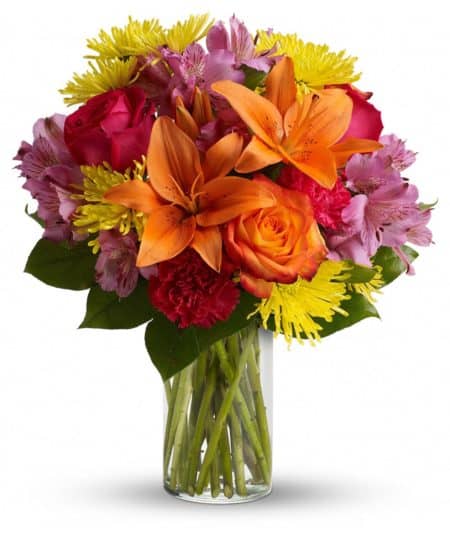 Express yourself colorfully with a brilliant array of roses, lilies and other favorites beautifully arranged in a sparkling clear glass cylinder vase. Perfect for a birthday, anniversary or any happy occasion.