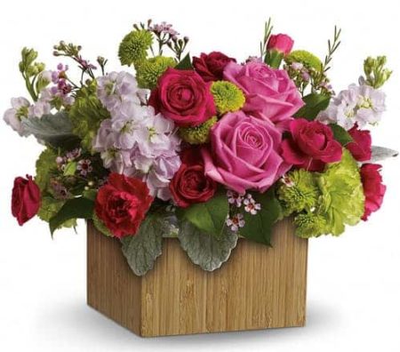 Put a smile on her face and a spring in her step with this delightful little garden bouquet. Presented in a chic bamboo box, its happy hot pinks and lovely lime greens give a colorful pick-me-up!