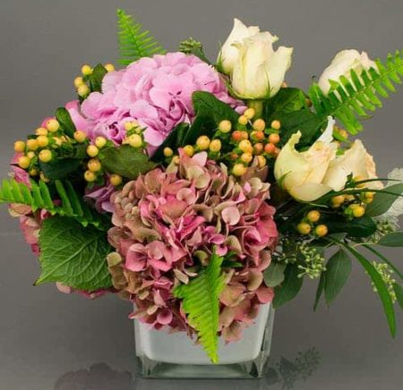 A classic collection of ever popular hydrangea from Holland and beautiful roses accented with seasonal foliage is appropriate for any occasion. Subtle and lush. Colors will vary based on availability, overall look and feel remains constant.