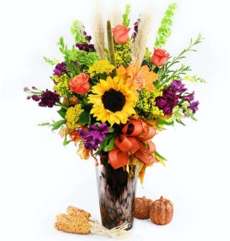 Sunflowers, organe roses and alstormeira and purrple and green accents make this a wonderful fall surprise.