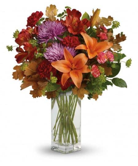 Brighten any fall day with this colorful array! Gorgeous orange lilies arranged with red and lavender blooms are sure to make someone smile!